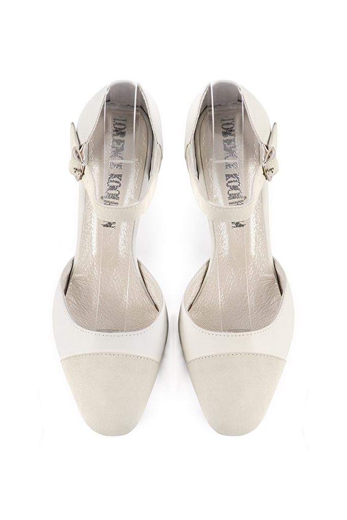 Women's off white open side dress shoes, with an instep strap. Round toe. Medium comma heels - Top view